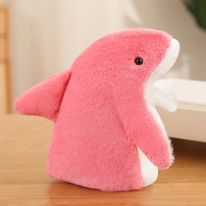 Detailed view of soft pink shark hand puppet plush with white belly on wooden surface