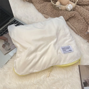 Detail of white quilted laptop sleeve with soft texture and bright yellow zipper accent