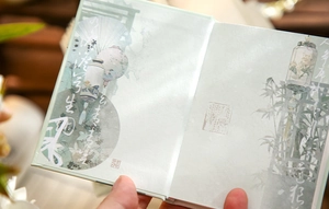 Detail of A7 notebook showing traditional Chinese ink painting and bamboo illustrations