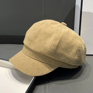 Macro side view of khaki plaid newsboy hat showing fine fabric texture and shape