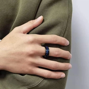 Close-up of black titanium steel ring for men featuring a blue chain inlay on finger
