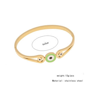 Detail view of gold evil eye stainless steel bangle with 6x5cm inner diameter specs