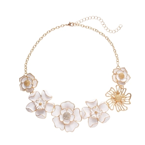 Elegant gold necklace featuring white enamel 3D flowers and sparkling crystal accents