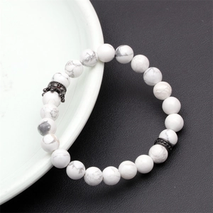 Detailed view of natural white howlite beads featuring a black zircon micro-pave crown charm