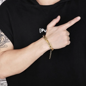 Detailed view of men's chunky gold-plated stainless steel chain bracelet with lobster clasp