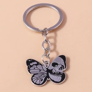 Macro view of Gothic butterfly skull keychain charm with dark silver zinc alloy finish