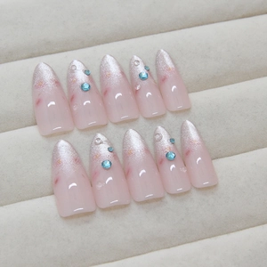 Pink gradient cat-eye press-on nails with silver glitter and blue rhinestones