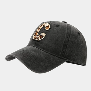 Vintage black washed cotton baseball cap with leopard print C patch and curved brim