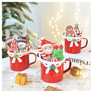 Three festive Christmas clay mugs with snowman, santa and gingerbread man figurines