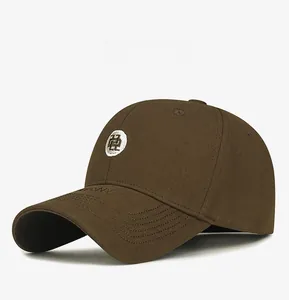 Detail of dark brown cotton baseball cap featuring a white circular embroidered logo patch