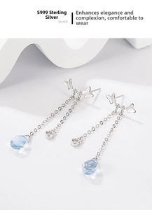 Macro detail of S999 silver butterfly earrings with moonstone tassels and zircon accents