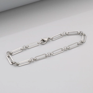 Close-up of a silver stainless steel paperclip chain bracelet with a lobster clasp