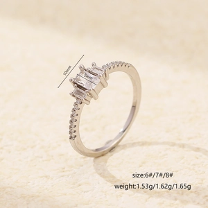 S925 Sterling Silver Ring with three square zircons and diamonds on textured background