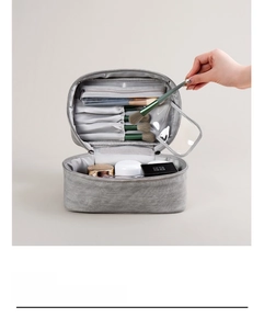 Detail view of cosmetics organizer with brush slots and transparent zipper pockets