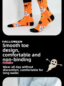 Detail of Halloween socks with orange patterns of black cats pumpkins and ghosts