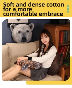 Plush animal head throw pillows featuring polar bear and leopard print designs on a sofa