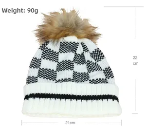 Knitted beanie with checkerboard pattern and faux fur pom-pom including dimensions 22x21cm