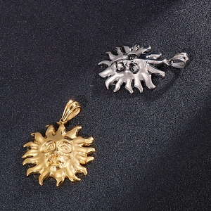 Detailed view of gold and silver sun deity pendants in rock hip hop style titanium steel