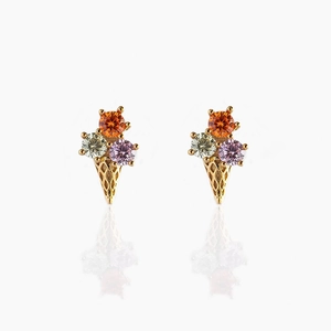 Close-up of 18K gold lollipop ice cream studs with orange, purple, and yellow zircons