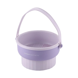 Purple collapsible makeup brush cleaning bowl with textured bottom and sturdy handle