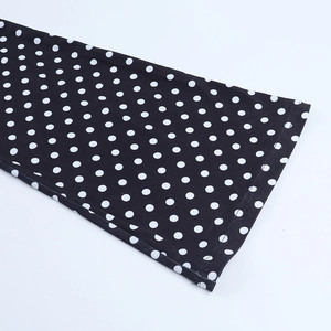 Detail of the high-quality double-stitch sewing on the black and white polka dot fabric