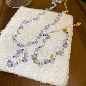 Floral beaded jewelry set with necklace bracelet and ring in purple and white beads