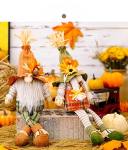 Detail of harvest gnomes with maple leaf hats and straw accents in autumn setting