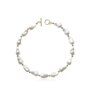 Detailed view of Baroque pearl necklace with gold beads and a toggle OT clasp closure