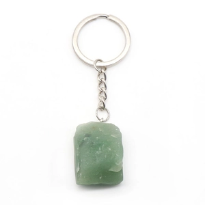 Natural green stone keychain with silver metal ring and chain on a white background