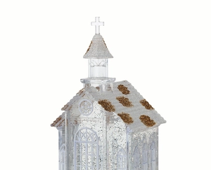 Detail of crystal church music box with gold glitter roof and festive snowy finish