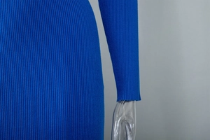 Close-up of bright blue ribbed knit dress showing detailed texture and sleeve stitching