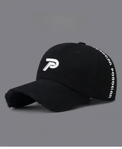 Detailed view of black distressed baseball cap with white embroidered P and Porcelain letters