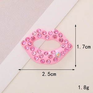 Macro detail of pink rhinestone lips charm with dimensions 2.5cm width and 1.7cm height