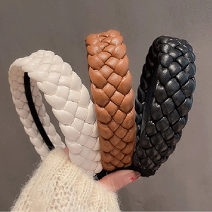 Three twisted PU leather headbands in white, brown, and black colors for women