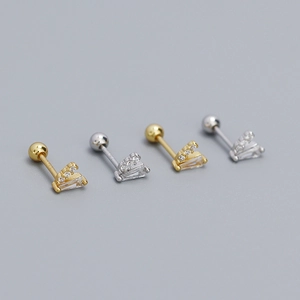 Macro detail of S925 silver V-shaped stud earrings with gold and silver finishes