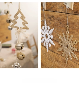 Detail of glittery Christmas tree and snowflake ornaments with bells and silk ribbons