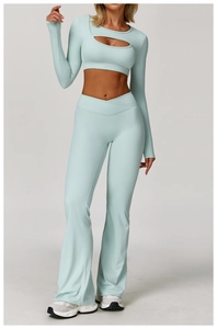 Front view of two-piece mint green yoga set with long sleeves and flared pants