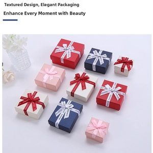 Detailed view of textured jewelry boxes with elegant ribbon bows and crystal jewelry text