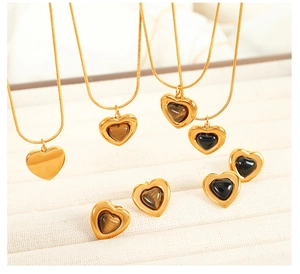 Macro detail of heart-shaped tiger eye stone necklaces and matching earrings set