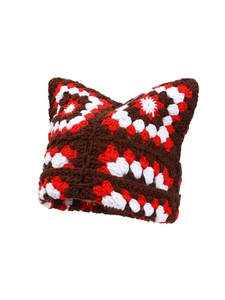 Close-up of handmade crochet cat ear hat featuring brown, red, and white knit texture