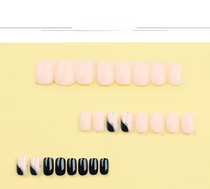 Detailed flat lay of light pink and black press-on nails with silver glitter accent lines