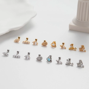 Variety of zircon stud earrings in gold and silver finish displayed on a clean background