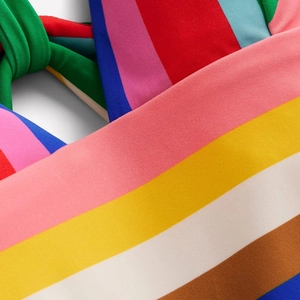 Detail of colorful striped stretch fabric with knot craft for dopamine style swimwear