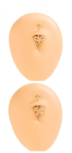 Detail of a gold butterfly belly button ring with white cubic zirconia on a model