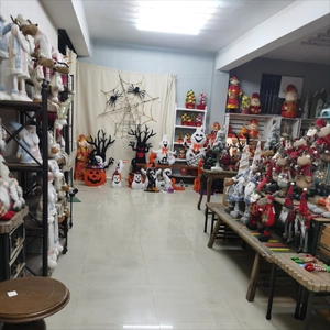 Showroom display featuring plush reindeer dolls and festive Christmas tree ornaments