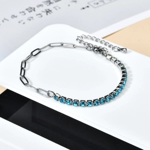 Detail of a 3mm blue crystal tennis bracelet combined with sleek silver chain links