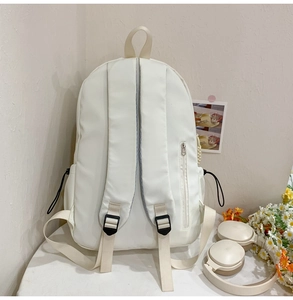 Detail view of large nylon backpack straps and anti-theft zipper on the back panel