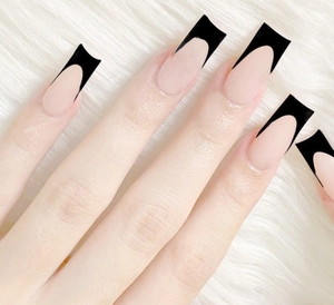 French manicure long square nails featuring nude pink base with deep black V-tips