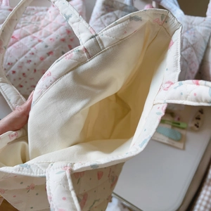 Detailed interior of a quilted floral tote bag showing cotton lining and wide opening