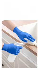 Close-up of durable blue nitrile gloves with extended cuffs used for kitchen cleaning tasks